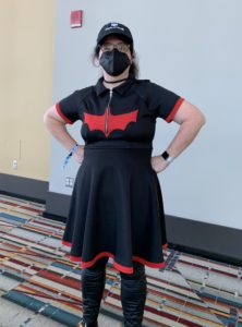 Author Corrina Lawson wearing a black and red batwoman costume and a black mask