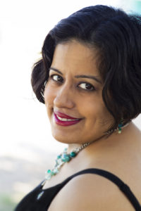 Head shot of author Suleikha Snyder looking over her shoulder at the camera